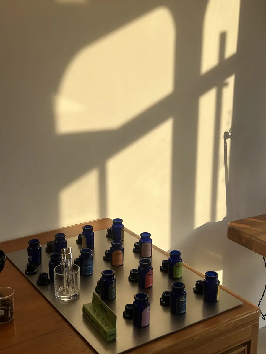 le plein été scent bar with blue apothecary bottles in afternoon light